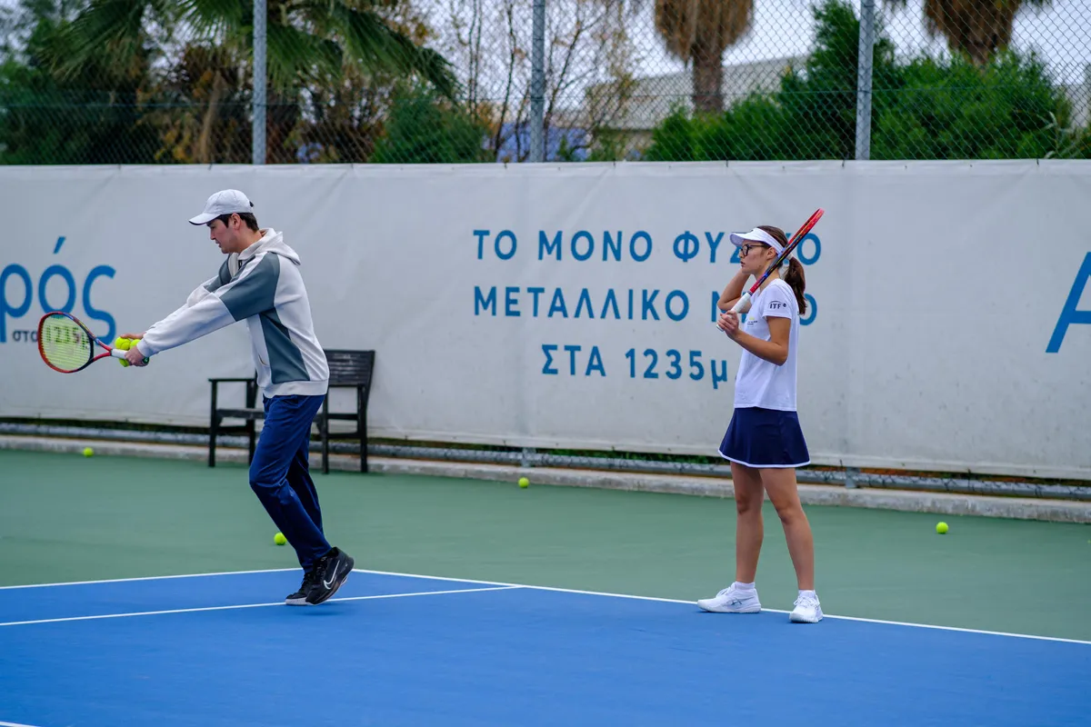A coach feeding a ball during an academy training session
